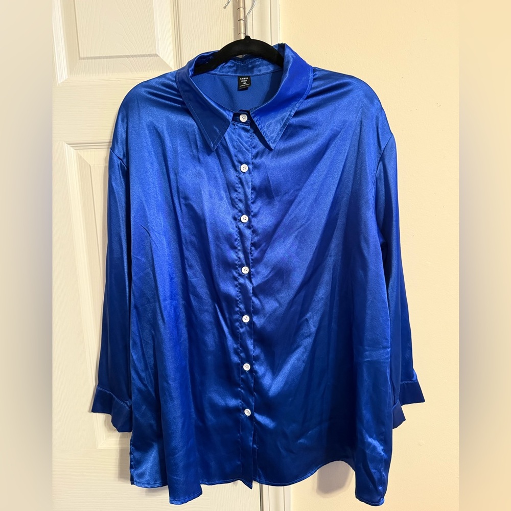 Blue satin blouse with white buttons
